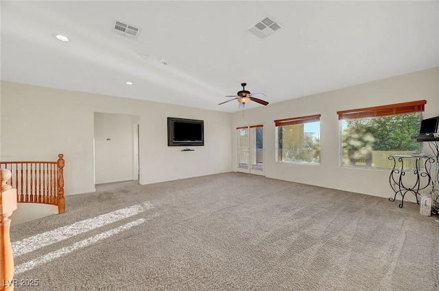 unfurnished living room featuring carpet, visible vents, and recessed lighting