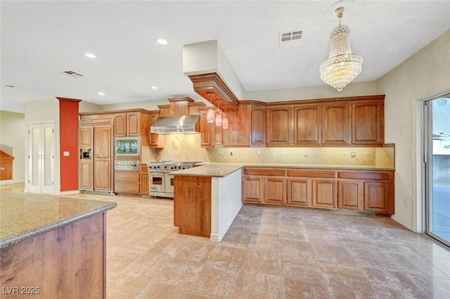 kitchen with visible vents, light countertops, double oven range, built in microwave, and wall chimney exhaust hood