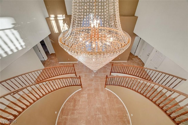 stairs featuring a notable chandelier