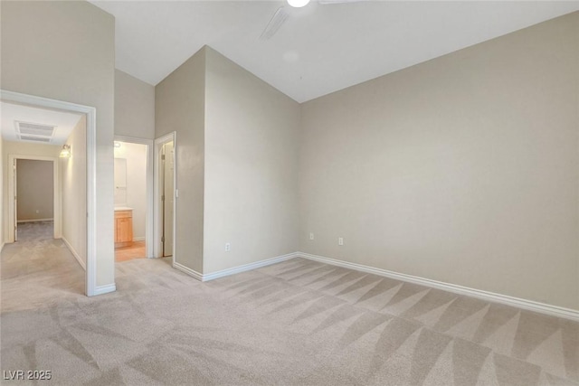 unfurnished bedroom featuring visible vents, light carpet, connected bathroom, high vaulted ceiling, and baseboards