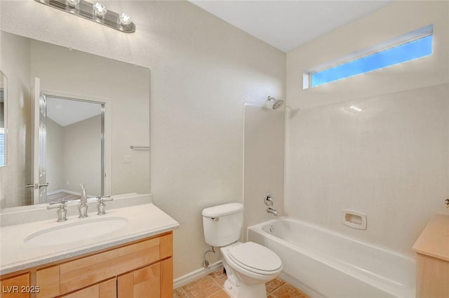 bathroom with bathtub / shower combination, toilet, vanity, baseboards, and tile patterned floors