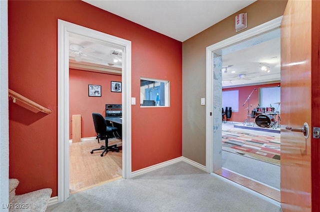 office featuring light carpet, visible vents, and baseboards