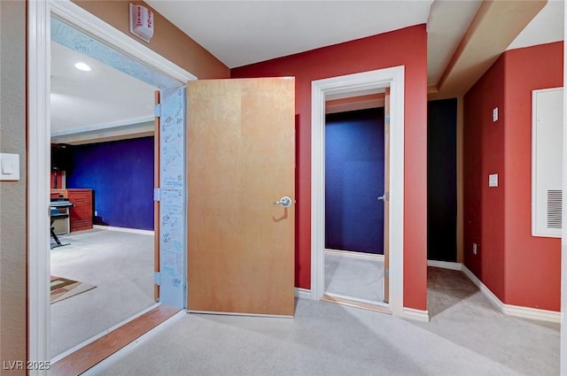 interior space with light carpet and baseboards