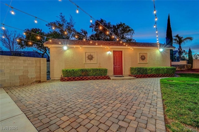 view of front of property with fence and stucco siding