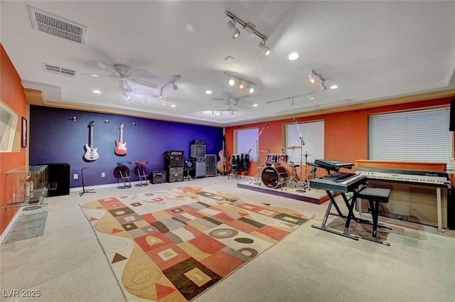 interior space with ceiling fan, a textured ceiling, light carpet, and visible vents