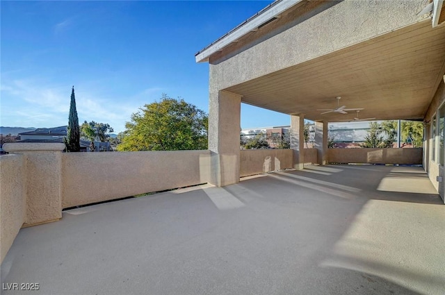 view of patio / terrace featuring fence and a ceiling fan