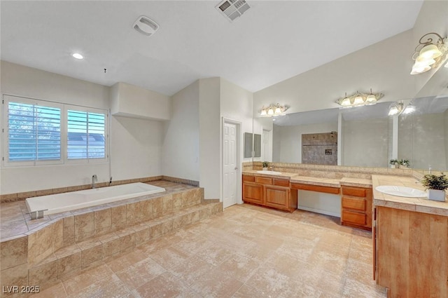 full bathroom with a tile shower, vanity, a garden tub, and visible vents