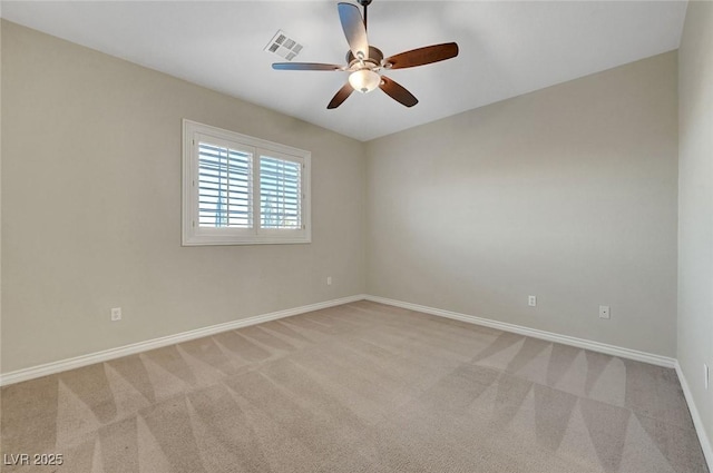 spare room with baseboards, a ceiling fan, visible vents, and light colored carpet