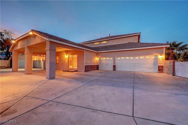 view of front of home featuring concrete driveway and an attached garage