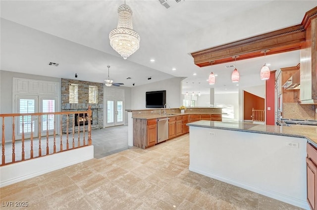 kitchen featuring dishwasher, open floor plan, visible vents, and light stone countertops