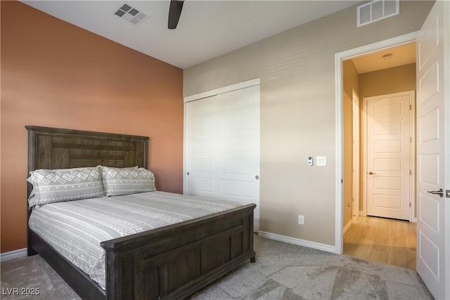 bedroom featuring light carpet, a closet, and ceiling fan