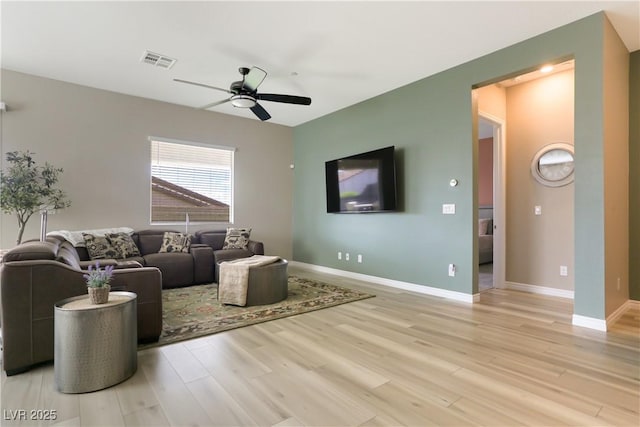 living room with hardwood / wood-style floors and ceiling fan