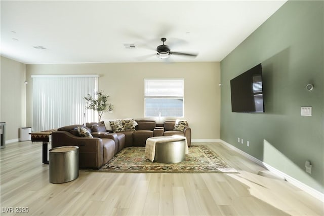 living room featuring ceiling fan and light hardwood / wood-style flooring