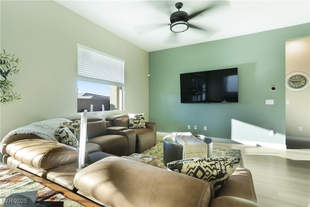 living room featuring wood-type flooring and ceiling fan