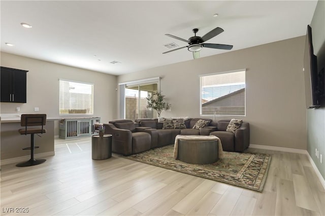 living room featuring ceiling fan and wood-type flooring