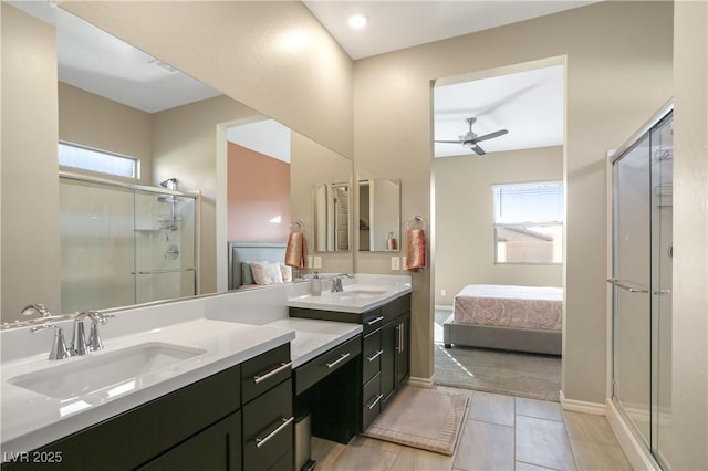 bathroom with ceiling fan, a healthy amount of sunlight, a shower with door, and vanity