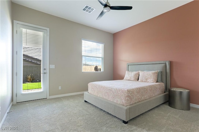 bedroom featuring access to exterior, light colored carpet, and ceiling fan