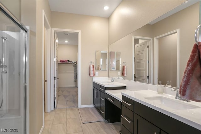 bathroom with walk in shower and vanity