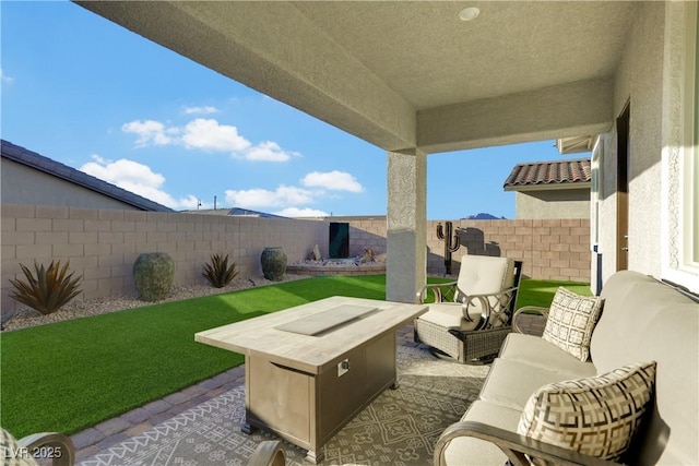 view of patio featuring an outdoor living space with a fire pit