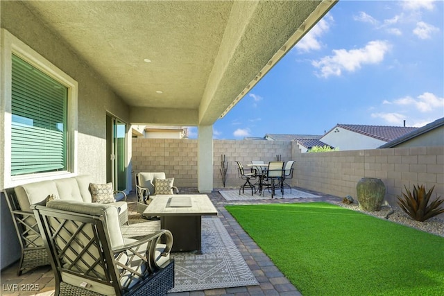 view of patio featuring an outdoor living space with a fire pit