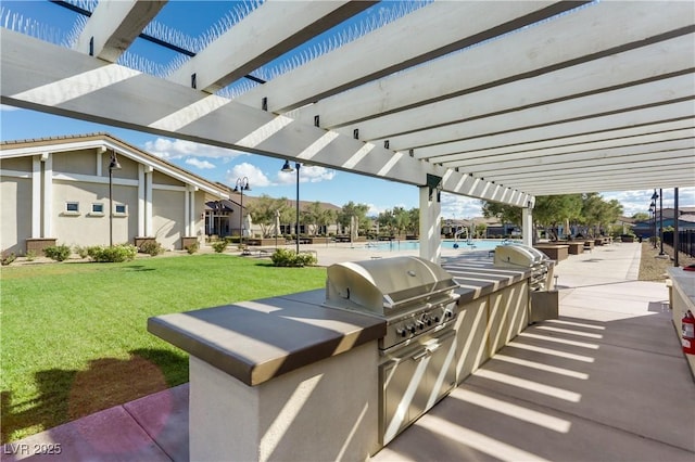 view of patio featuring area for grilling, a pergola, and exterior kitchen