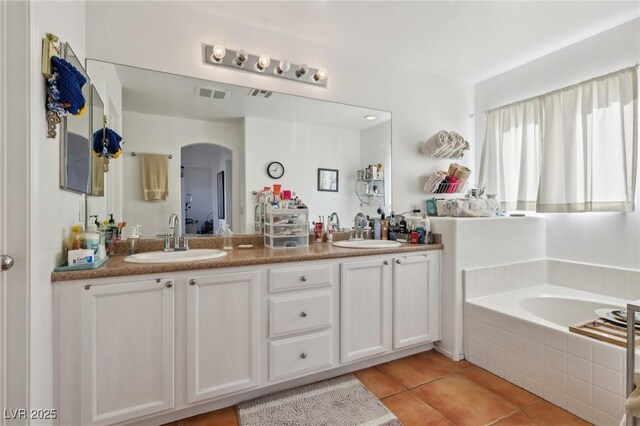 6527 Netherseal Ave, Las Vegas, NV 89139 - bathroom featuring tile patterned floors, vanity, and tiled tub