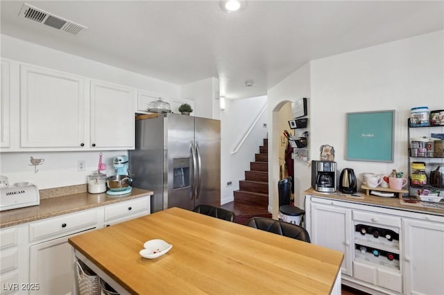 6527 Netherseal Ave, Las Vegas, NV 89139 - kitchen with white cabinetry and stainless steel refrigerator with ice dispenser