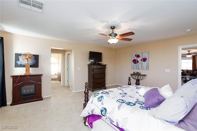 bedroom with ceiling fan and light carpet