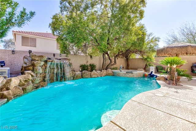 view of swimming pool featuring an in ground hot tub, pool water feature, and a patio