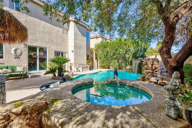 view of swimming pool with an in ground hot tub and a patio