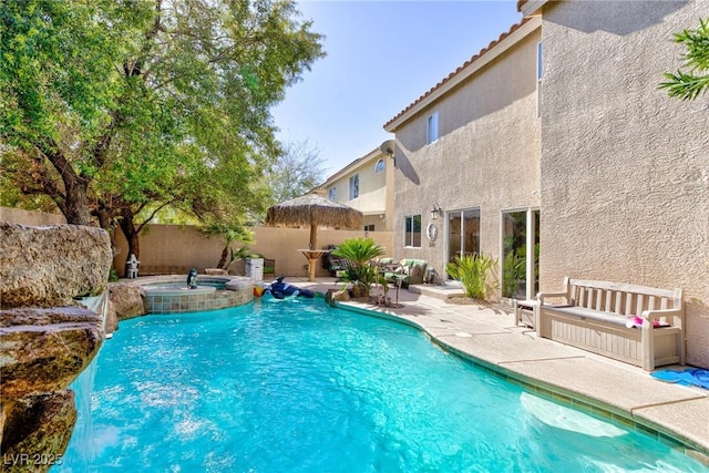 view of pool with an in ground hot tub and a patio