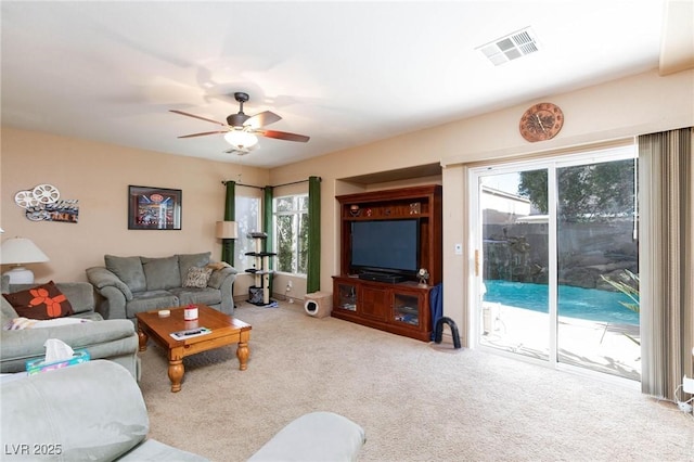 carpeted living room featuring ceiling fan