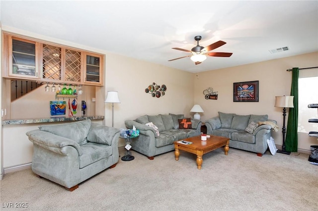 carpeted living room featuring ceiling fan