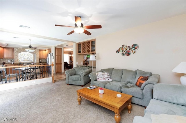 carpeted living room featuring ceiling fan