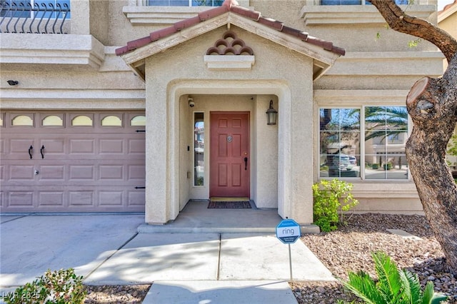 doorway to property with a garage