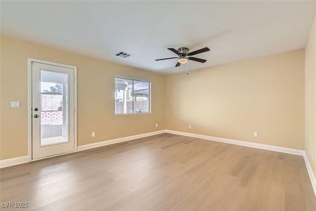 empty room featuring hardwood / wood-style floors and ceiling fan