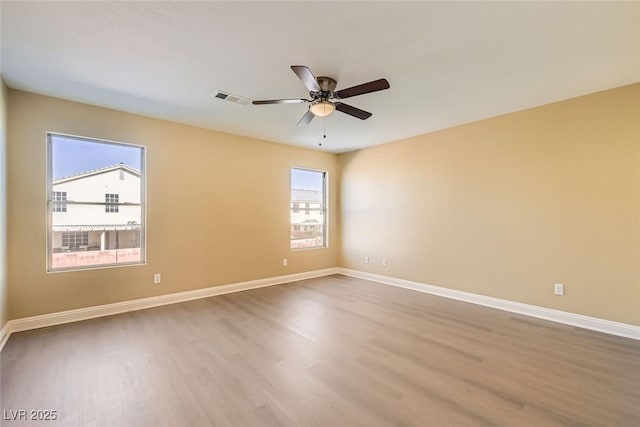 spare room featuring hardwood / wood-style flooring and ceiling fan