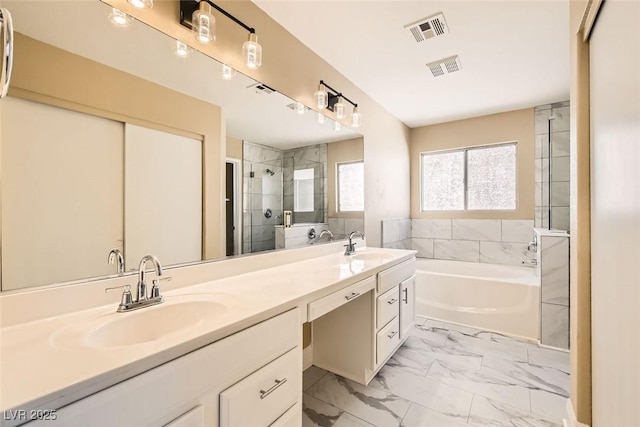 bathroom with vanity and separate shower and tub