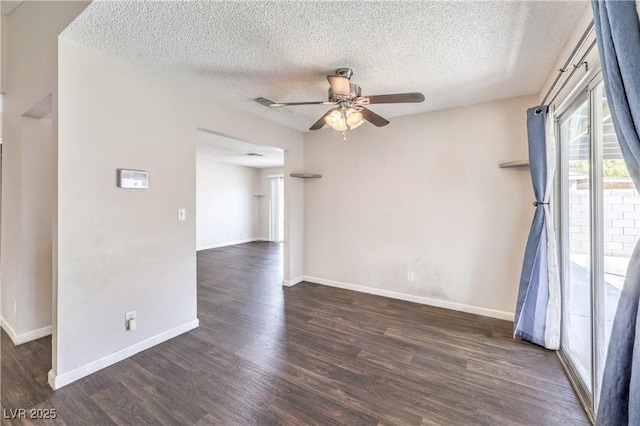 spare room with a textured ceiling, dark wood-style floors, baseboards, and ceiling fan