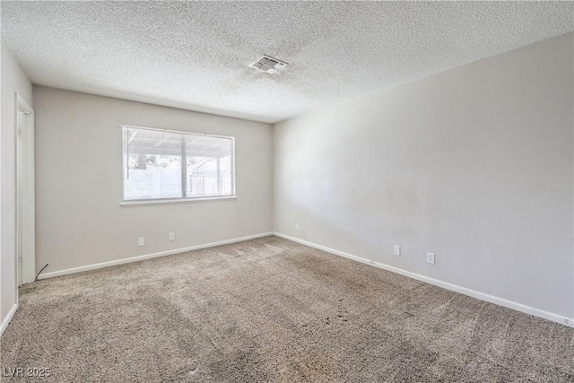 carpeted empty room with visible vents, baseboards, and a textured ceiling