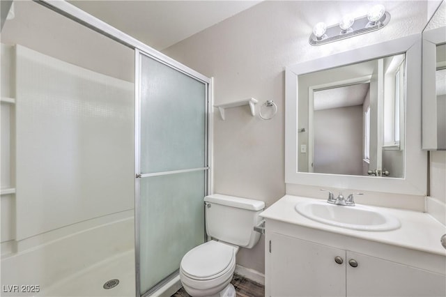 full bath featuring vanity, toilet, and a stall shower