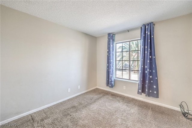 empty room with baseboards, carpet floors, and a textured ceiling