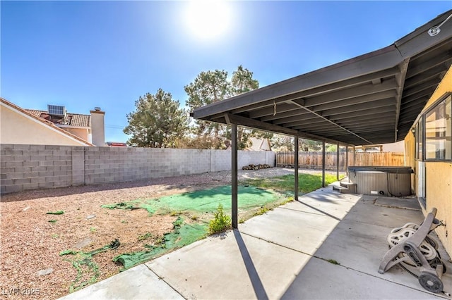 view of patio / terrace featuring central AC, a hot tub, and a fenced backyard