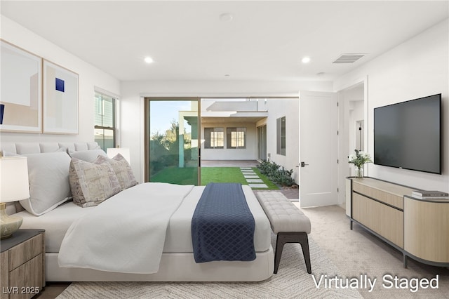 bedroom with multiple windows and light carpet