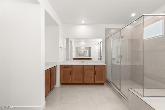 bathroom featuring vanity, an enclosed shower, and tile patterned flooring