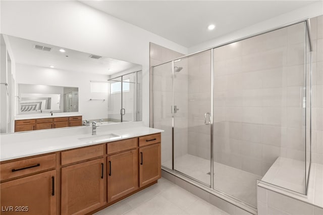 bathroom featuring vanity, tile patterned flooring, and a shower with door