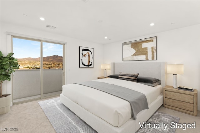 bedroom featuring light carpet, a mountain view, and access to exterior