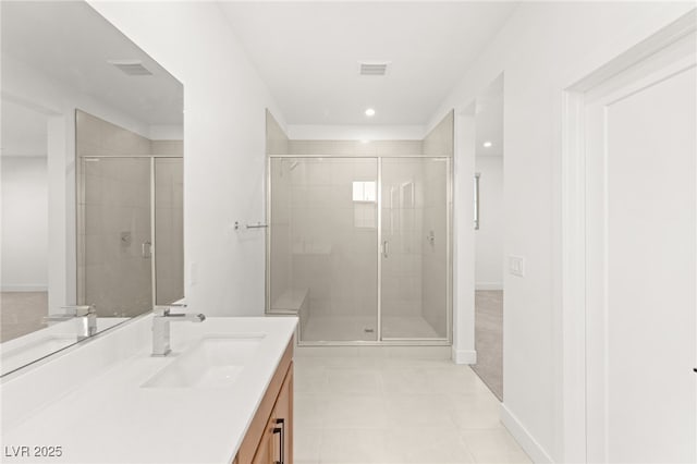 bathroom with vanity and a shower with shower door