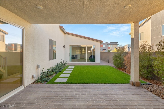 exterior space with a patio area and a lawn