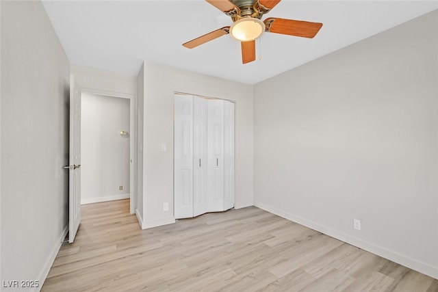 unfurnished bedroom with ceiling fan, light hardwood / wood-style floors, and a closet